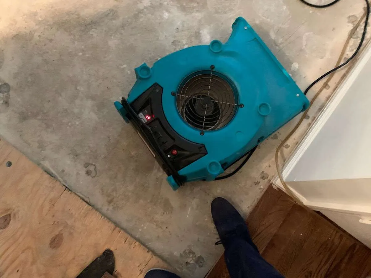 Air mover drying subfloor during Commercial Water Damage Restoration in Woodstock